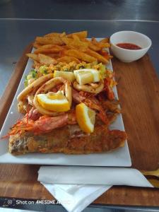a plate of food with fish and french fries at Lifestyle Lodge Hotel in Vereeniging