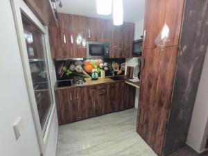 a kitchen with wooden cabinets and a counter top at Suite ultra moderne Wi-Fi in Yaoundé