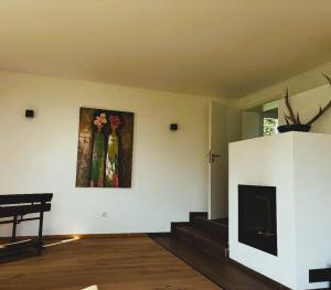 ein Wohnzimmer mit Kamin und einem Gemälde an der Wand in der Unterkunft 23 Mattenham - Rückzugsort in Abgeschiedenheit in Vilshofen an der Donau