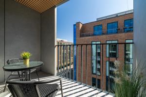 a patio with a table and chairs on a balcony at City Break Śląska 8 by INA in Gdańsk
