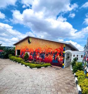 a building with a mural on the side of it at Kalpho Art Center Guesthouse- near Embassy District in Kigali