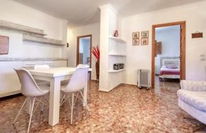a living room with a white table and chairs at villa cap marti in El Tosalet