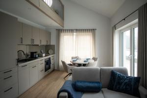 a living room with a couch and a table at Flutgold Dangast in Dangast