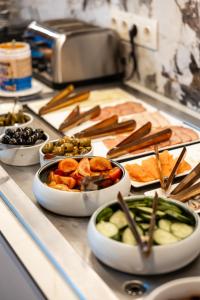 a group of bowls of food on a counter at Suncity Hotel & SPA in Šiauliai