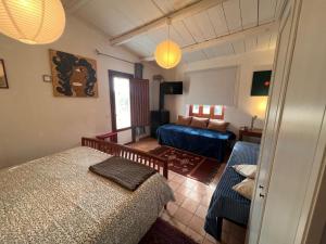a bedroom with a bed and a couch in a room at La Rosa dei Monti Iblei in Ferla