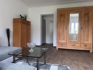 a living room with a coffee table and a dresser at NEU! Kleines Glück Illingen in Illingen