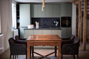 a kitchen with a wooden table and chairs at Ferienwohnung "Haus Lehlgässchen" in Reil +15 photos