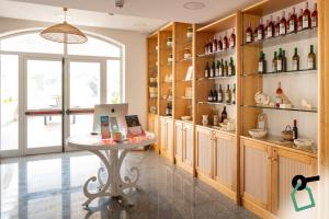 a room with a table and shelves of wine bottles at Hotiday Gallipoli Spiaggia in Baia Verde