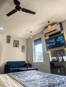 a bedroom with a bed and a flat screen tv at Hotel Jairaj in Alwar
