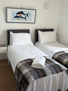 two beds sitting next to each other in a room at Cadgwith Cove Inn in Cadgwith