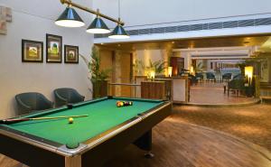 a room with a pool table in a hotel room at Savoy Suites Manesar in Gurgaon