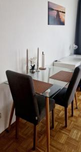 a dining room table with two chairs and a table with candles at Cozy and beautiful flat in the centrum in Essen