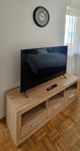 a flat screen tv sitting on top of a wooden entertainment center at Cozy and beautiful flat in the centrum in Essen
