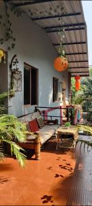 a living room with a couch and a table at Bageecha B&B- V A A Y U in Alībāg