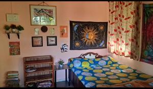a bedroom with a bed with a colorful comforter at Bageecha B&B- V A A Y U in Alībāg