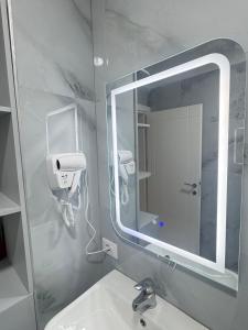 a bathroom with a mirror and a sink at Sunset Luxury Apartment Shengjin in Lezhë +42 photos