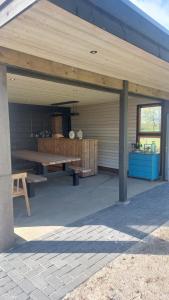 a pavilion with a picnic table and a bench at B&B Bos en Dal in Blesdijke
