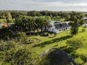 an aerial view of a white house with palm trees at Springfontein River Lodge in Stanford
