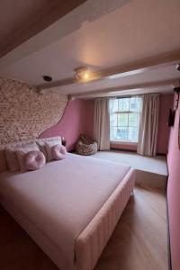 a bedroom with a large white bed and a window at BNB de Victorie Alkmaar in Alkmaar