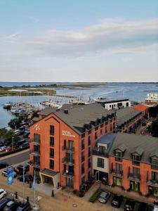 an aerial view of a building with a marina at Hafenhotel Meereszeiten in Heiligenhafen