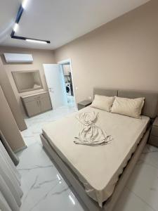 a bedroom with a large bed in a room at Sunset Luxury Apartment Shengjin in Lezhë