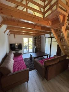 a living room with a couch and a table at Vikendica Casa Verde in Konjic