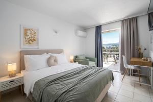 a bedroom with a bed and a view of a balcony at Flisvos in Sitia +82 photos