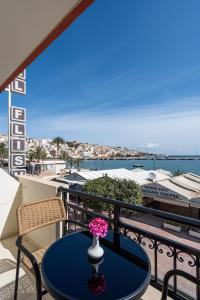 a table with a vase of flowers on a balcony at Flisvos in Sitia