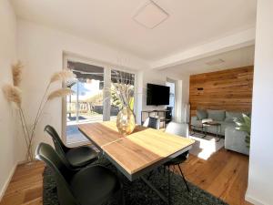 a living room with a wooden table and chairs at Ferienhaus Alpenlodge in Oberstdorf