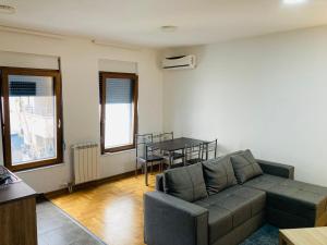 a living room with a couch and a table at Apartman 4 you 4 in Belgrade