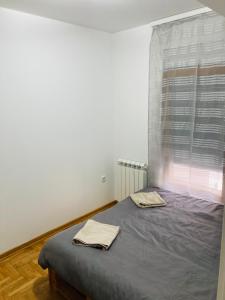 a bedroom with a bed with two towels on it at Apartman 4 you 4 in Belgrade