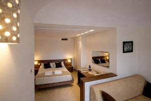 a hotel room with a bed and a sink at Zia Nì Boutique Suites in Peschici