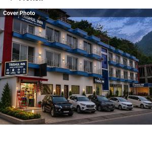 a group of cars parked in front of a building at Trishul inn in Rudraprayāg