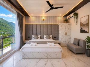 a bedroom with a large bed with a ceiling fan at Trishul inn in Rudraprayāg