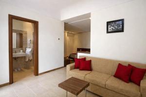 a living room with a couch and a bathroom at Zia Nì Boutique Suites in Peschici +37 photos