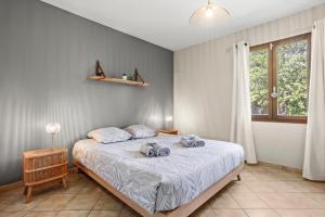 a bedroom with a bed with two towels on it at Villa 3 palmiers avec pisicne in Fréjus +14 photos