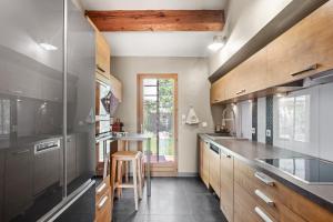 a kitchen with wooden cabinets and a counter top at Villa 3 palmiers avec pisicne in Fréjus