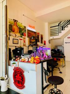 a restaurant with a counter and a chair in a room at Guest house Trung Hiếu in Rạch Giá