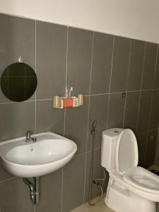 a bathroom with a sink and a toilet at Guest house Trung Hiếu in Rạch Giá