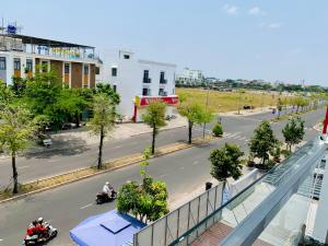 a view of a city street with motorcycles on the road at Guest house Trung Hiếu in Rạch Giá