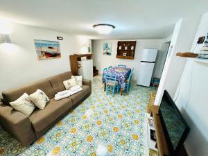 a living room with a couch and a table at Acqua Marina - UN LETTO IDEALE in Gaeta