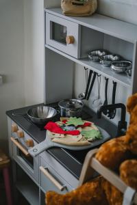 a kitchen with a stove with a pizza on it at Ööbikuoru Villa in Rõuge