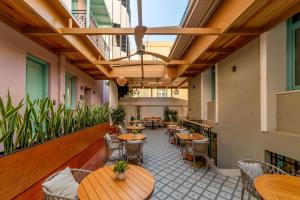 an empty restaurant with tables and chairs at Artion City Boutique Hotel in Heraklio