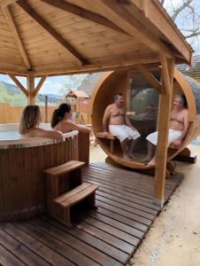 a group of people sitting in a hot tub at KLOBUCKÉ RETRO bydlení a wellness in Valašské Klobouky +35 photos