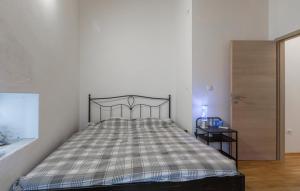 a bedroom with a bed with a plaid bedspread at Marija's House in Bale