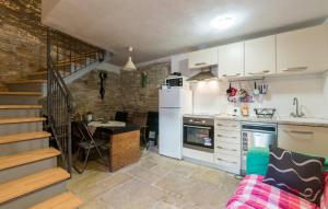 a kitchen with a staircase and a kitchen with a table at Marija's House in Bale