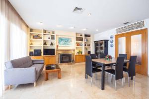 a living room with a table and a couch at Villa Carousel in Benidorm