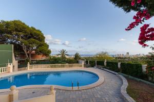 a swimming pool in the backyard of a house at Villa Carousel in Benidorm