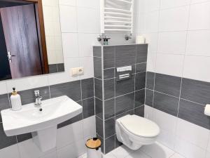 a bathroom with a toilet and a sink at Astral in Raszyn