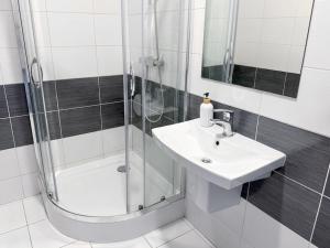 a bathroom with a sink and a shower at Astral in Raszyn +58 photos